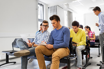 Image showing group of students with papers in lecture hall