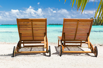 Image showing tropical beach with palm tree and sunbeds