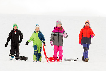 Image showing happy little kids with sleds in winter