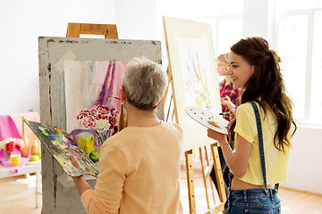 Image showing happy women painting at art school studio