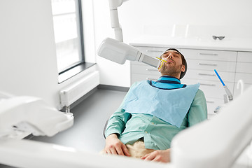 Image showing patient having x-ray scanning at dental clinic