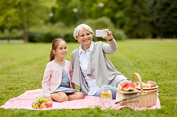 Image showing grandmother and granddaughter take selfie at park