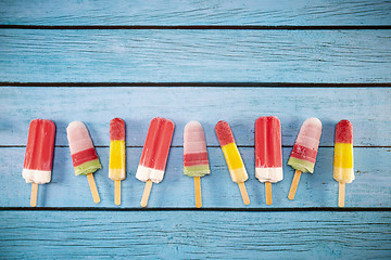 Image showing Ice cream stick placed on a blue vintage wooden 