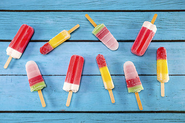 Image showing Ice cream stick placed on a blue vintage wooden 