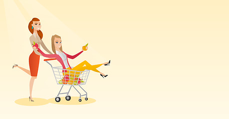 Image showing Couple of friends riding in shopping trolley.