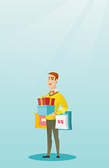 Image showing Caucasian man holding shopping bags and gift boxes