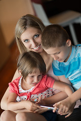 Image showing Young Family Using A Tablet To Make Future Plans