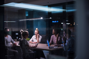 Image showing Multiethnic startup business team in night office