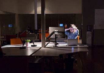 Image showing businessman relaxing at the desk