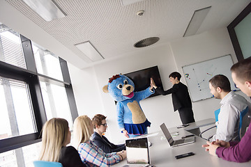 Image showing boss dresed as bear having fun with business people in trendy of