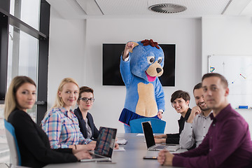 Image showing boss dresed as bear having fun with business people in trendy of