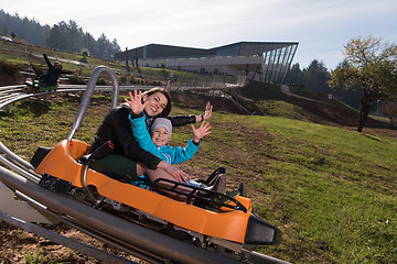 Image showing mother and son enjoys driving on alpine coaster