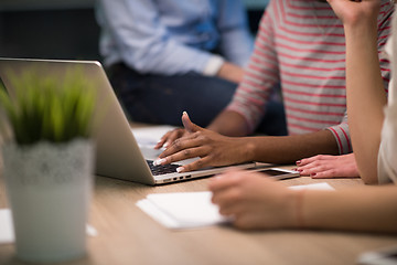 Image showing Multiethnic startup business team in night office