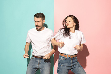 Image showing A couple of young man and woman dancing hip-hop at studio.