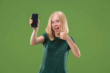 Image showing Portrait of a confident casual girl showing blank screen mobile phone