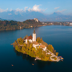 Image showing Aerial view of Bled island on lake Bled, and Bled castle and mountains in background, Slovenia.