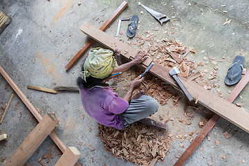 Image showing Carpenter working in traditional manual carpentry shop in a third world country.