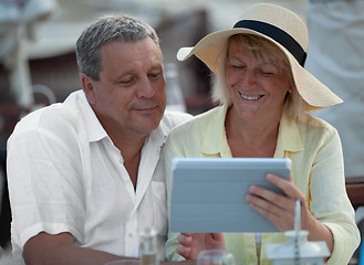 Image showing Cheerful mature couple with touch pad outdoor