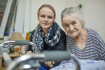 Image showing A portrait of two women, young and elderly, sitting close to each other