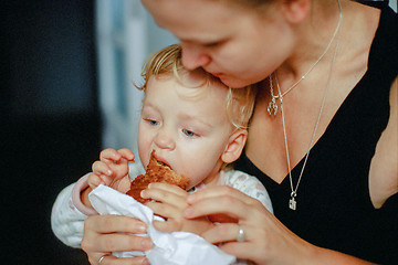 Image showing Feeding a baby with pastry