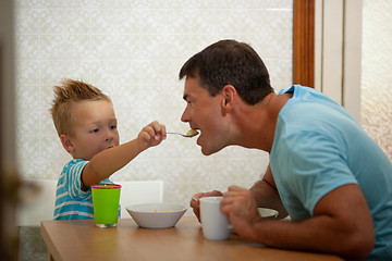 Image showing Spoon-feeding of a father