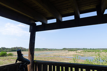 Image showing Spotting scope on a tripod in a bird watching tower