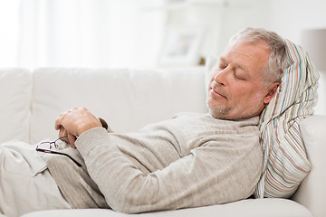 Image showing senior man sleeping on sofa at home