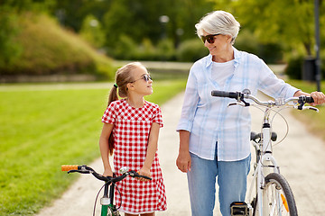 Image showing grandmother and granddaughter with bicycles