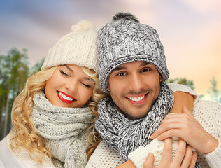 Image showing couple hugging over winter forest background