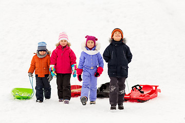 Image showing happy little kids with sleds in winter