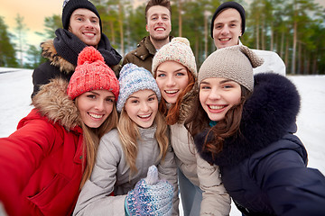 Image showing group of friends taking selfie outdoors in winter