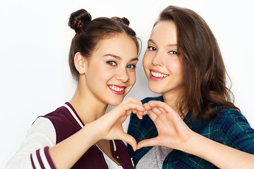 Image showing happy smiling teenage girls showing heart sing