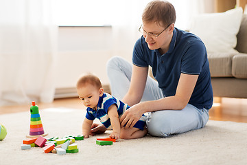 Image showing happy father with baby son playing toys at home