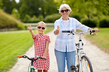 Image showing grandmother and granddaughter with bicycles