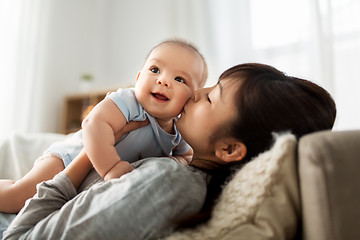 Image showing happy mother kissing little baby son at home