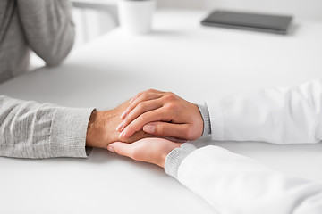 Image showing close up of doctor holding senior patient hand
