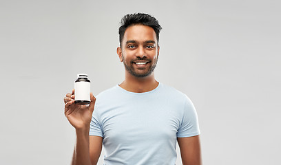 Image showing indian man with medicine over grey background