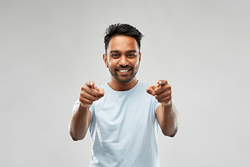 Image showing smiling indian man pointing fingers at you