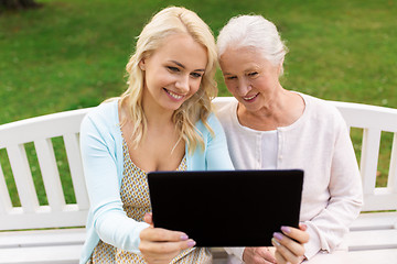 Image showing daughter with tablet pc and senior mother at park