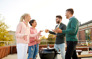 Image showing happy friends having bbq party on rooftop