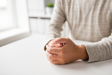 Image showing senior man hands on table