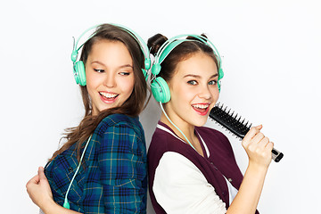 Image showing teenage girls in earphones listening to music