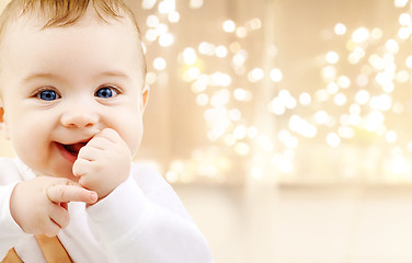 Image showing close up of sweet baby over christmas lights