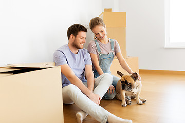 Image showing happy couple with boxes and dog moving to new home