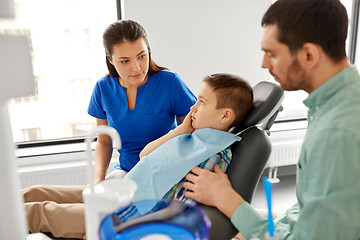 Image showing father and son visiting dentist at dental clinic