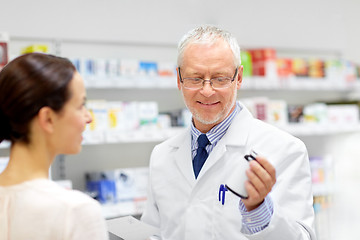 Image showing apothecary and woman with drug at pharmacy