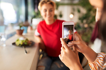 Image showing women having lunch and photographing at cafe