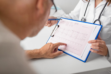 Image showing senior man and doctor with cardiogram at hospital