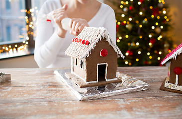 Image showing woman making gingerbread houses on christmas