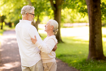 Image showing happy senior couple dancing at summer park